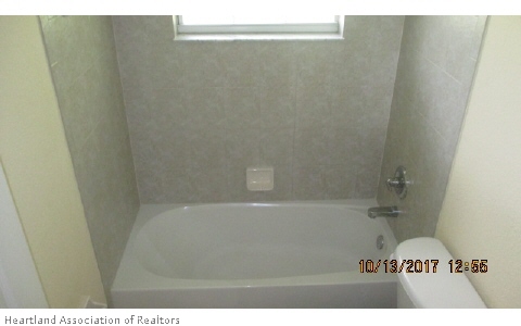 4441 Loquat Road Sebring, FL 33875 - Photo 6 of 6 a bathroom with a bathtub
