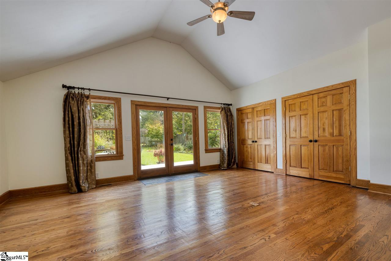 15 Wembley Road Greenville, SC 29607 - Photo 22 of 36 Family room with vaulted ceilings, view of the garden and the most convenient storage. Wall to wall shelving, attractively hidden behind 4 easy to access door.