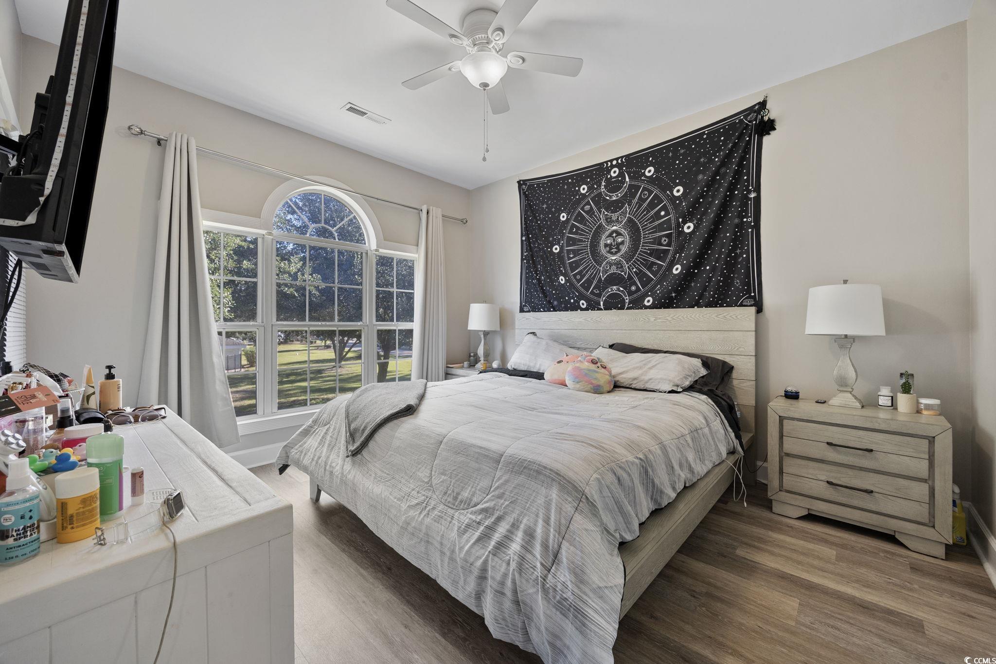 4639 Wild Iris Drive, Unit 203 Myrtle Beach, SC 29577 - Photo 18 of 30 Bedroom featuring wood finished floors and ceiling fan