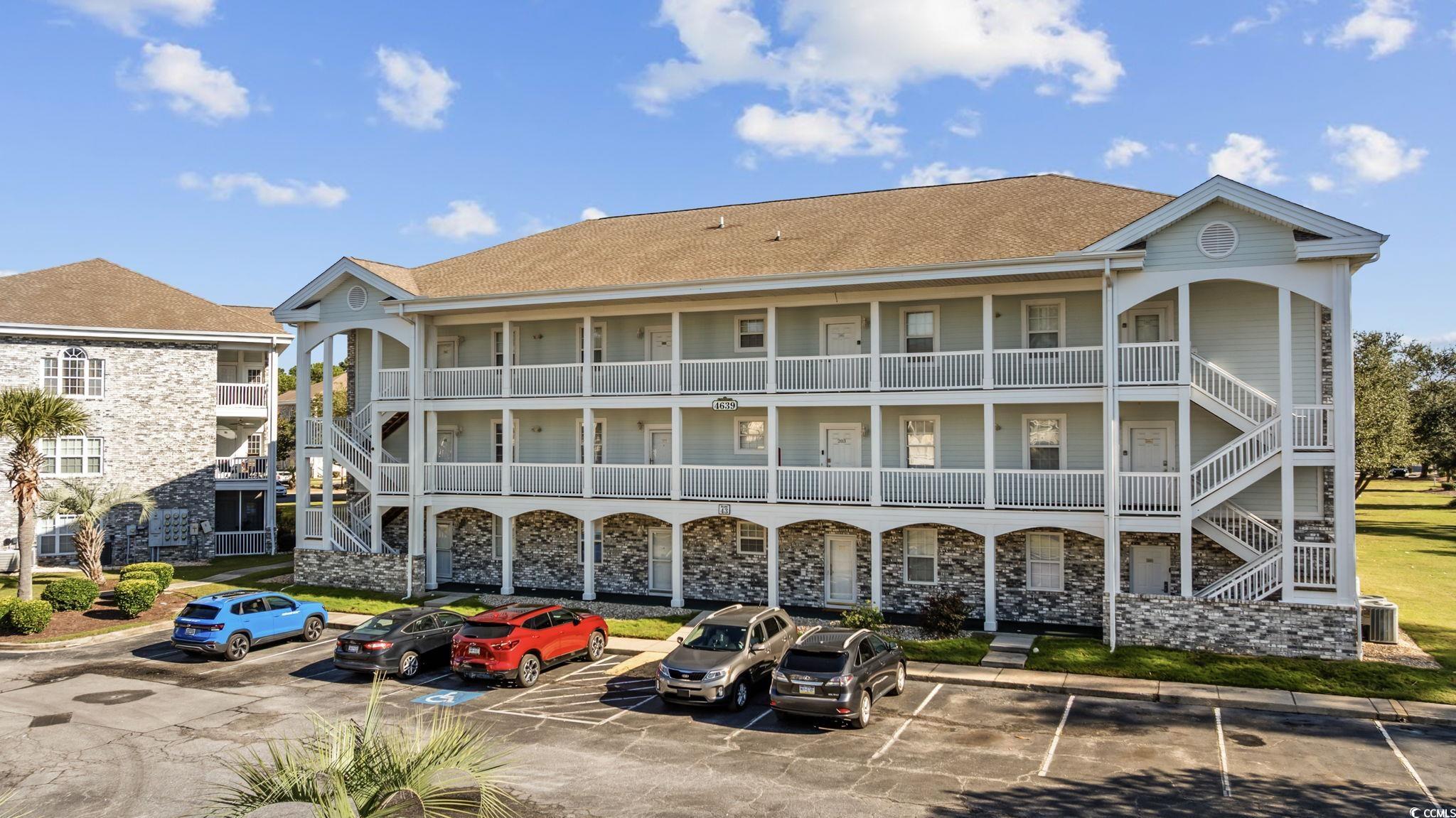 4639 Wild Iris Drive, Unit 203 Myrtle Beach, SC 29577 - Photo 2 of 30 View of building exterior with uncovered parking
