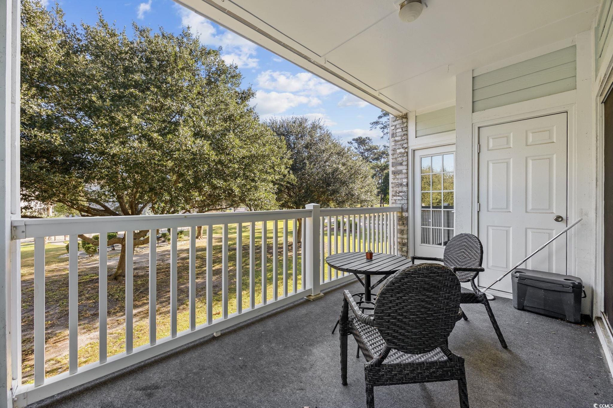 4639 Wild Iris Drive, Unit 203 Myrtle Beach, SC 29577 - Photo 21 of 30 Balcony featuring view of wooded area