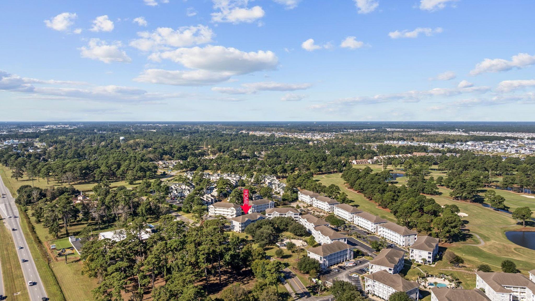 4639 Wild Iris Drive, Unit 203 Myrtle Beach, SC 29577 - Photo 30 of 30 Aerial overview of property's location featuring a golf course and a tree filled landscape
