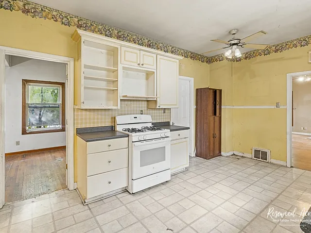 a kitchen with a stove cabinets and refrigerator