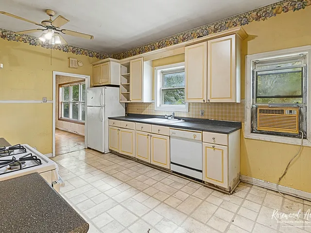 a kitchen with a sink stove and cabinets