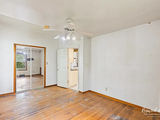 a view of an empty room with wooden floor