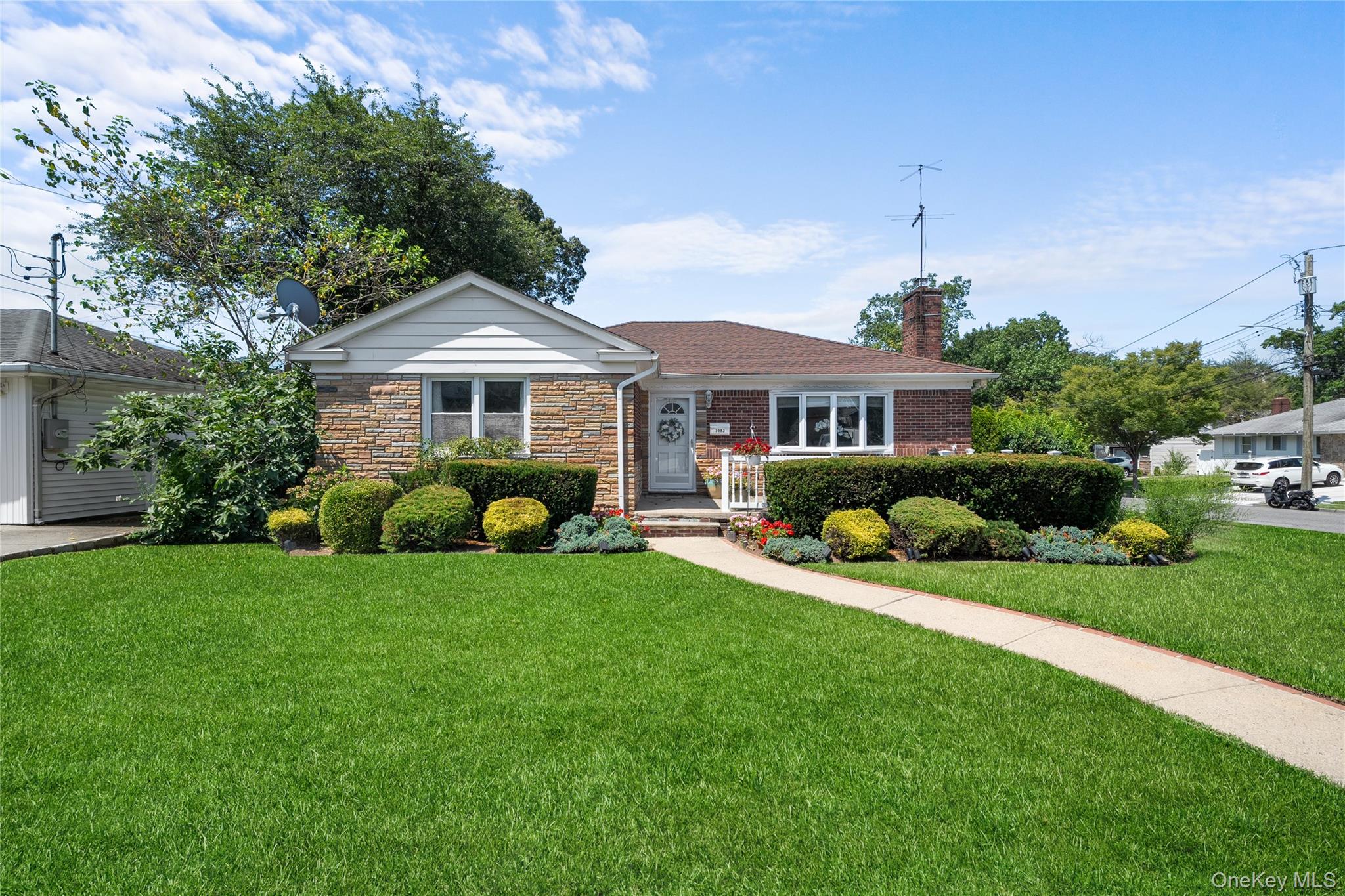 a front view of a house with a yard table and chairs