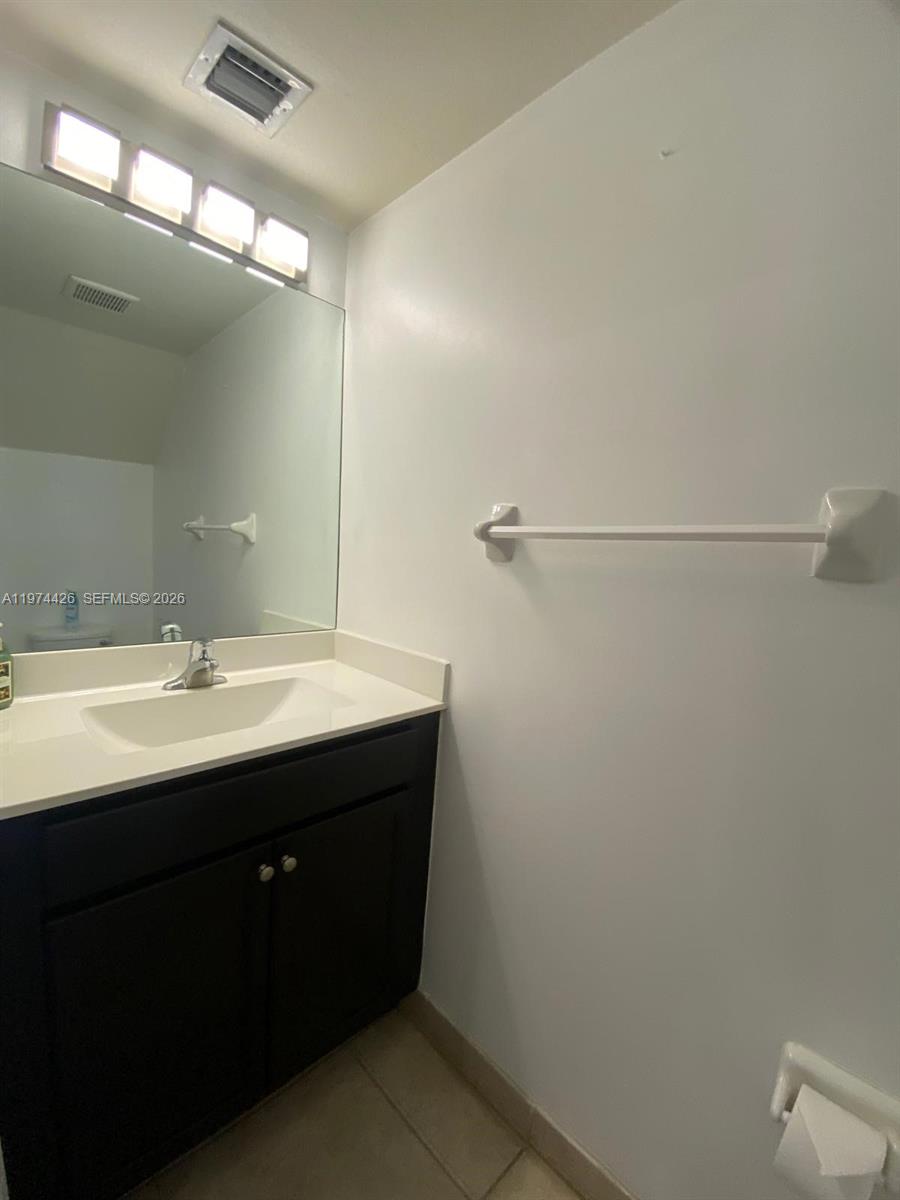 11543 Southwest 248th Lane Homestead, FL 33032 - Photo 14 of 32 a bathroom with a sink and mirror