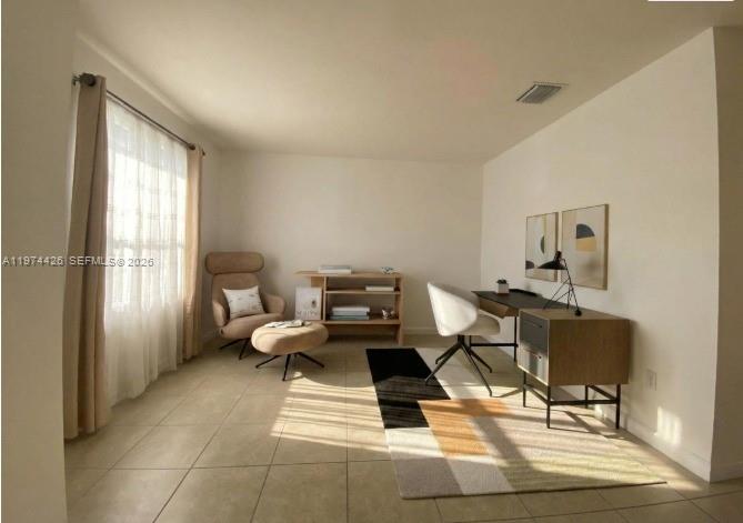 11543 Southwest 248th Lane Homestead, FL 33032 - Photo 15 of 32 a living room with furniture a window and gym equipment