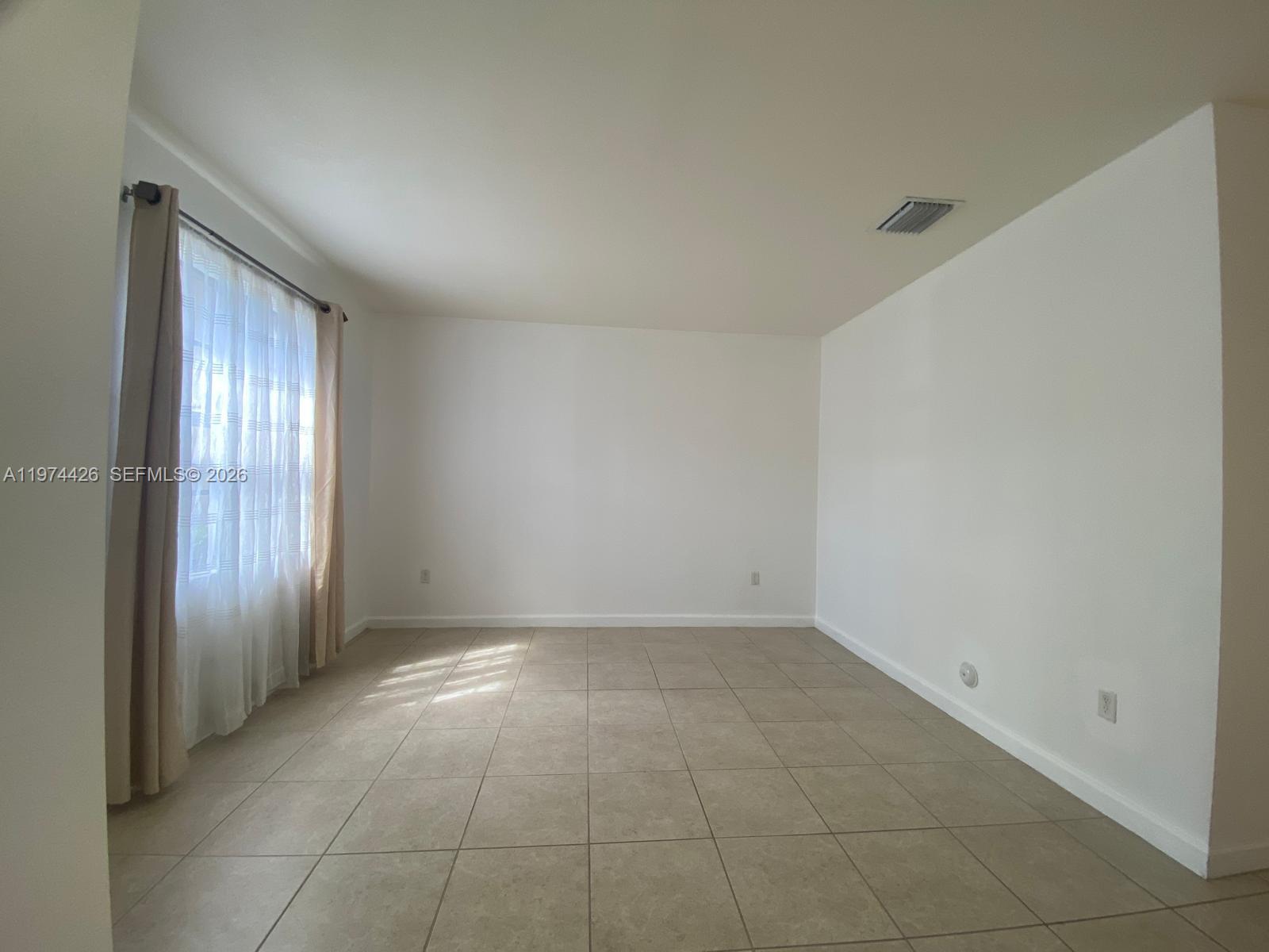 11543 Southwest 248th Lane Homestead, FL 33032 - Photo 16 of 32 an empty room with windows