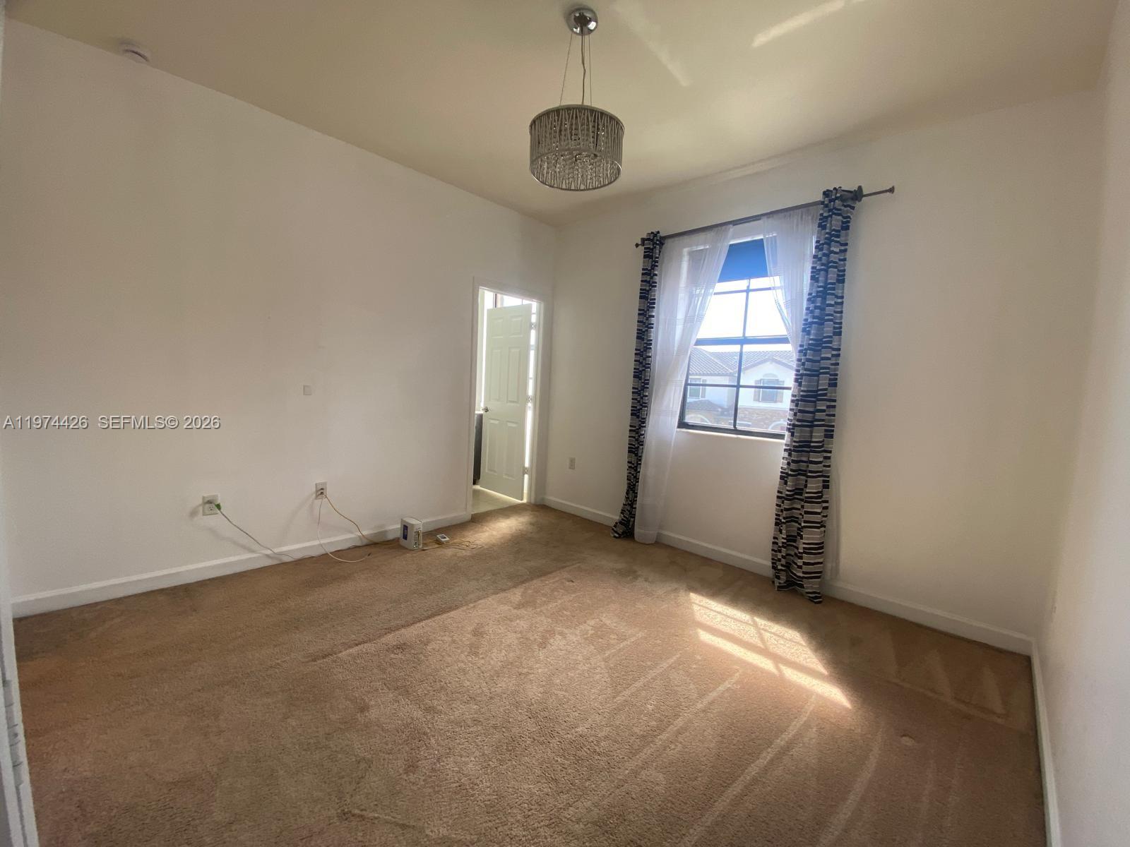 11543 Southwest 248th Lane Homestead, FL 33032 - Photo 21 of 32 a view of a room with window