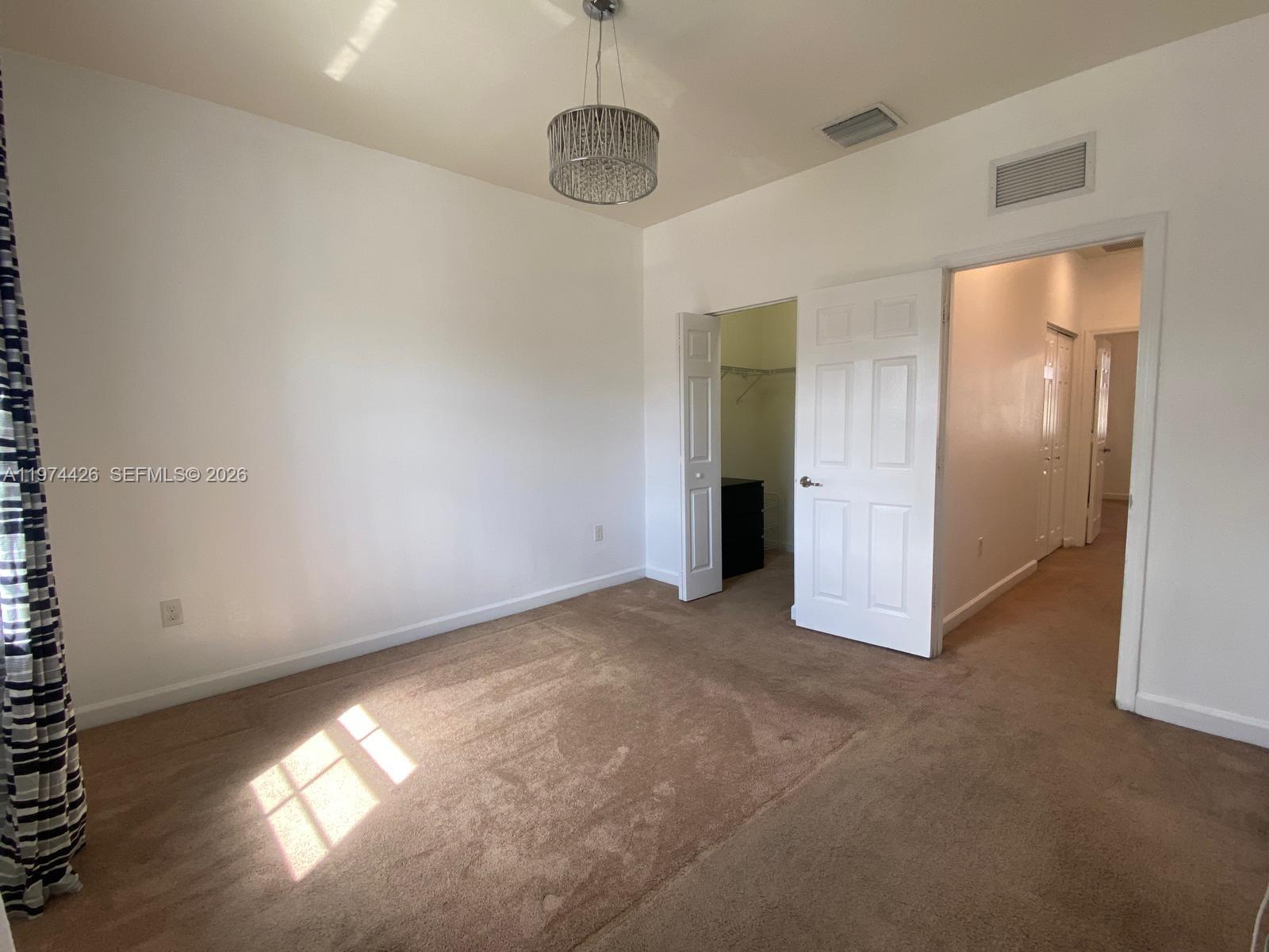 11543 Southwest 248th Lane Homestead, FL 33032 - Photo 22 of 32 an empty room with windows and closet