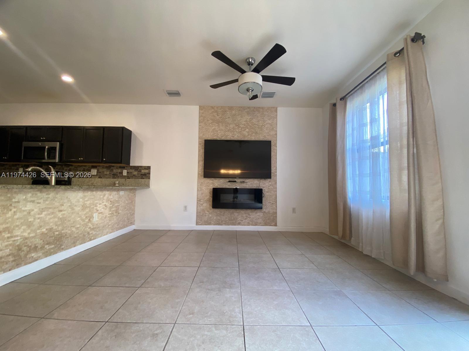 11543 Southwest 248th Lane Homestead, FL 33032 - Photo 3 of 32 a view of a livingroom with a staircase