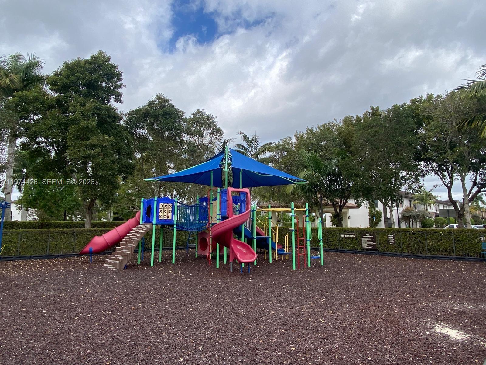 11543 Southwest 248th Lane Homestead, FL 33032 - Photo 31 of 32 a view of outdoor space with playground and green space