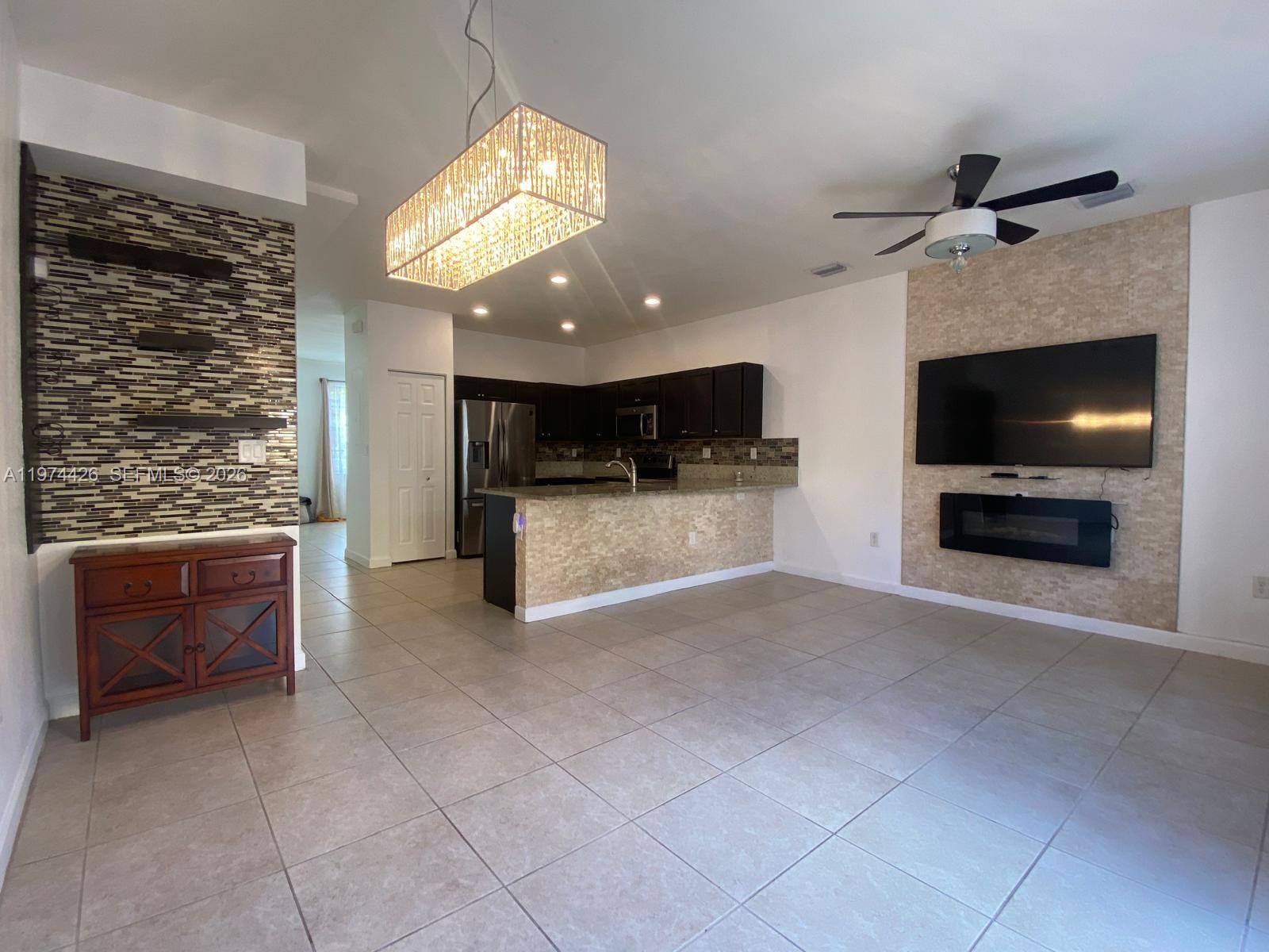 11543 Southwest 248th Lane Homestead, FL 33032 - Photo 8 of 32 a view of kitchen with microwave and cabinets