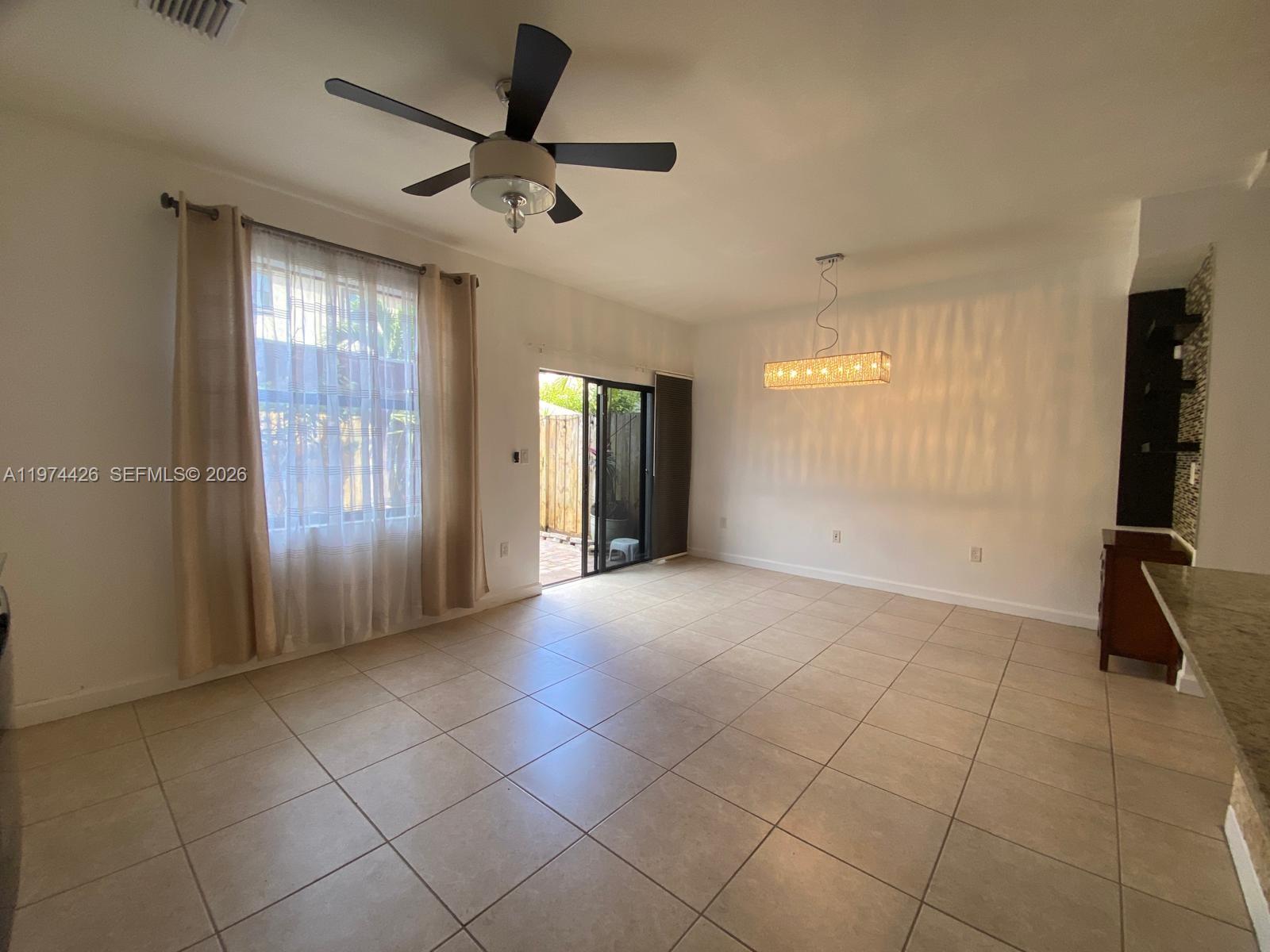 11543 Southwest 248th Lane Homestead, FL 33032 - Photo 9 of 32 a view of an empty room with a window