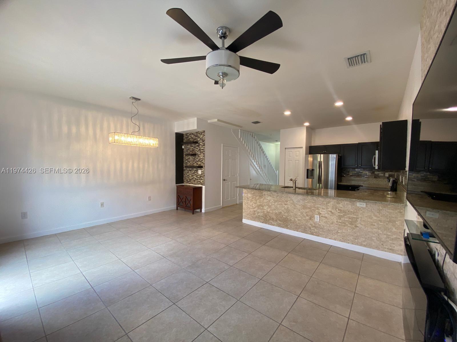 11543 Southwest 248th Lane Homestead, FL 33032 - Photo 10 of 32 a view of kitchen with a sink and a refrigerator