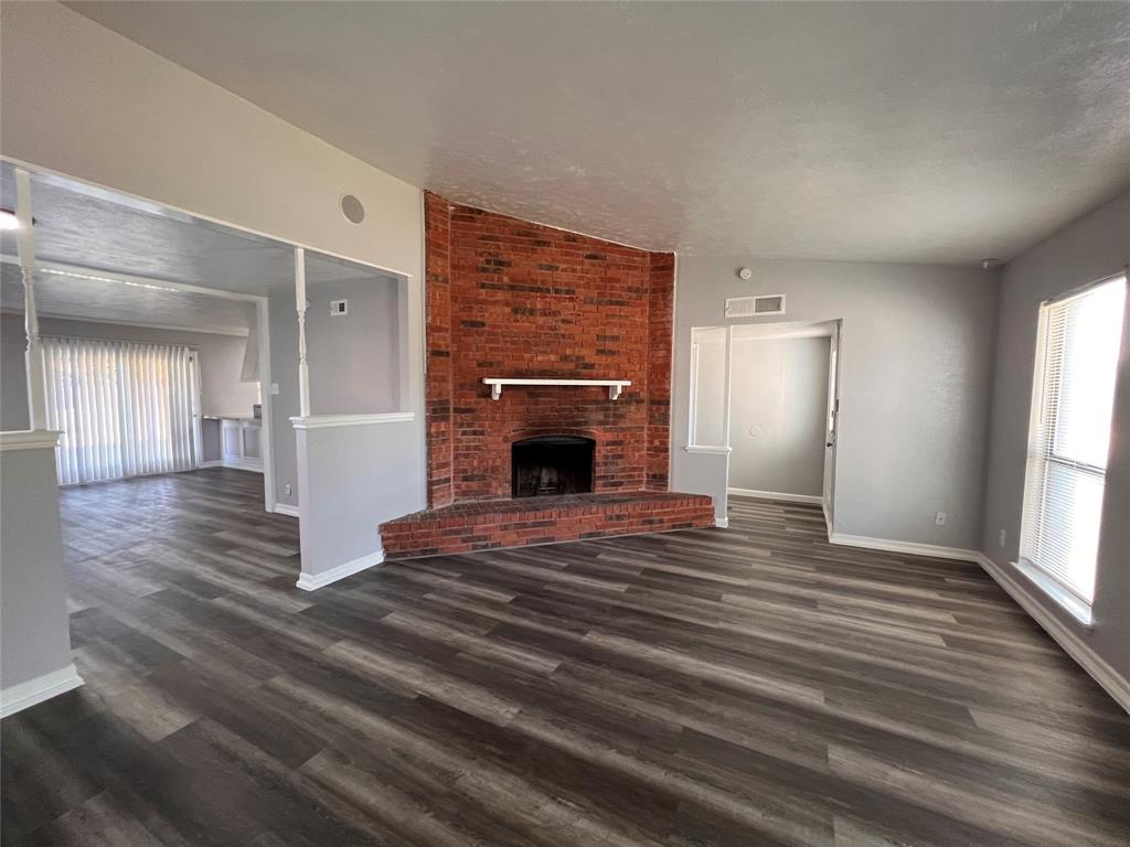 a view of empty room with window and fireplace