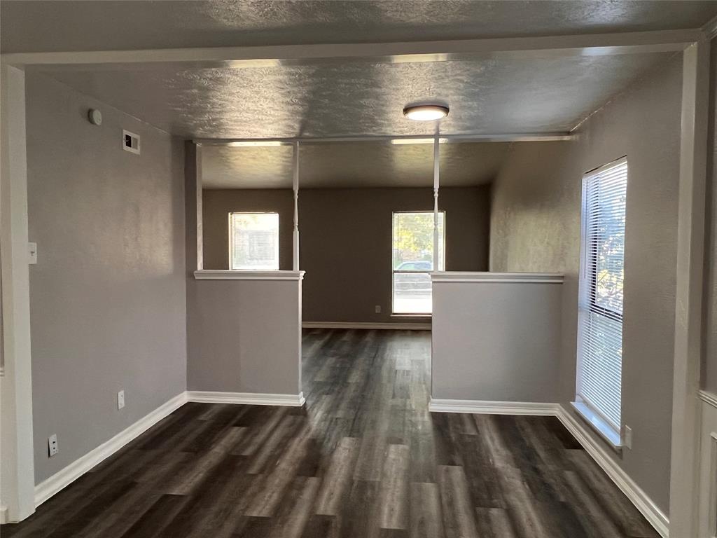 8506 Woodside Road Rowlett, TX 75088 - Photo 9 of 27 a view of a livingroom with wooden floor and a window