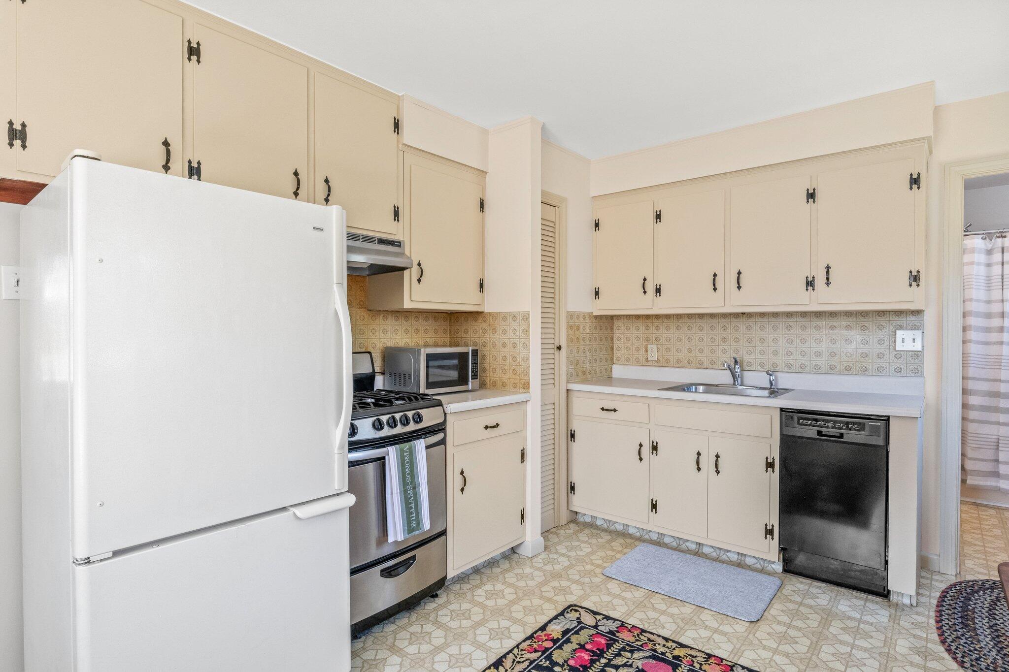 2 Long Road Harwich, MA 02645 - Photo 11 of 34 a kitchen with stainless steel appliances granite countertop a refrigerator sink stove and white cabinets