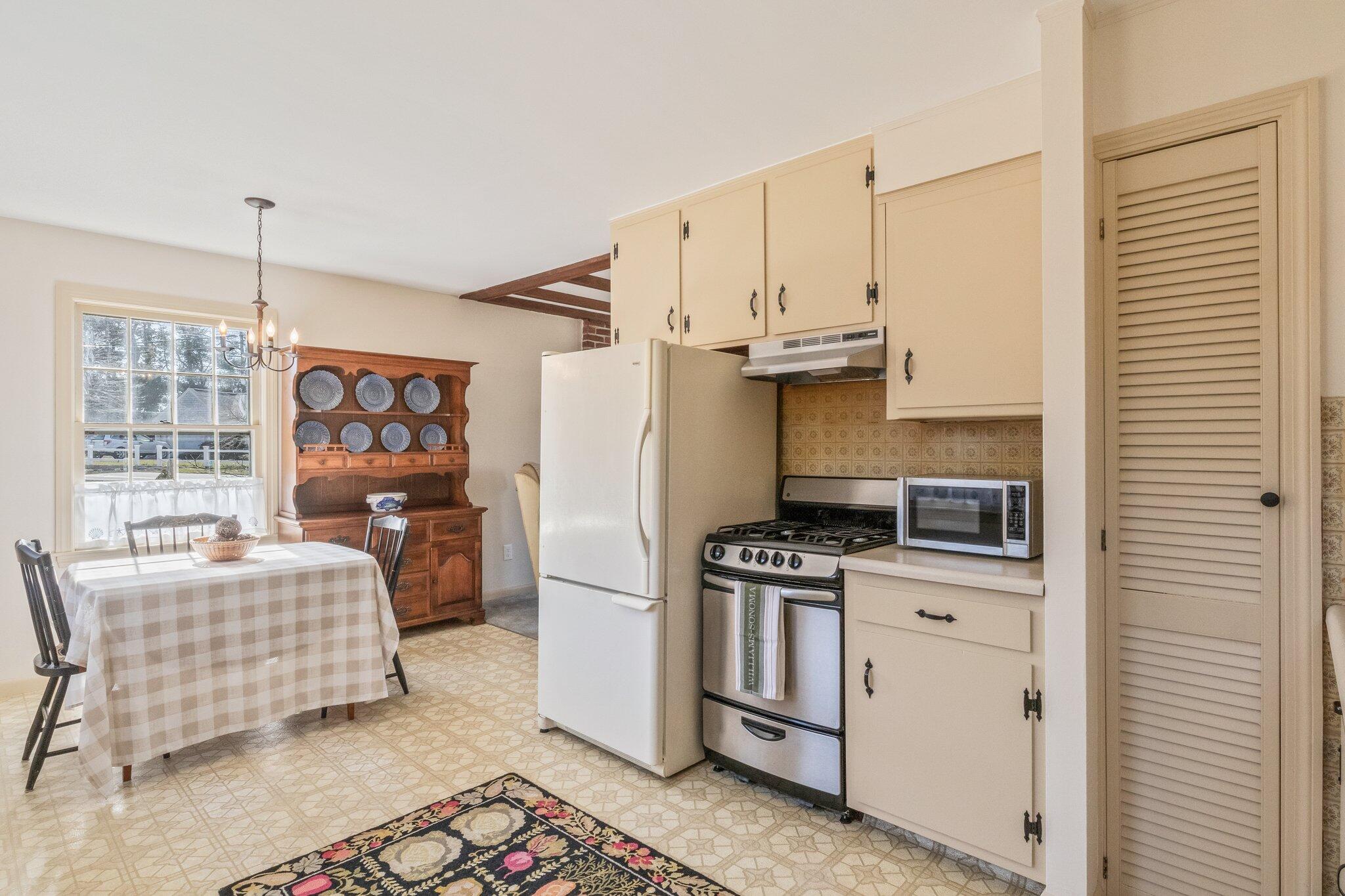 2 Long Road Harwich, MA 02645 - Photo 12 of 34 a kitchen with stainless steel appliances kitchen island granite countertop a stove a sink and a refrigerator