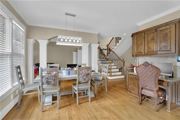 a view of a dining room with furniture window and wooden floor