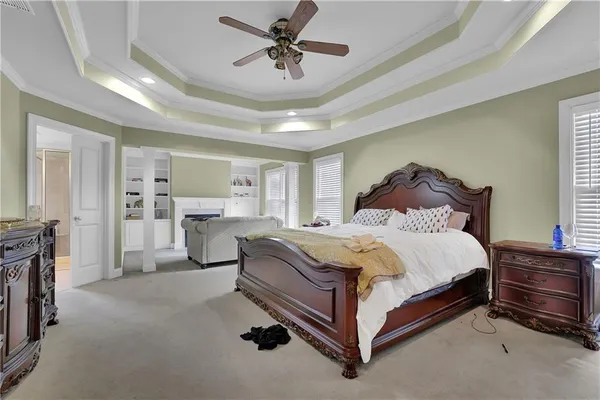 a spacious bedroom with a bed and a chandelier