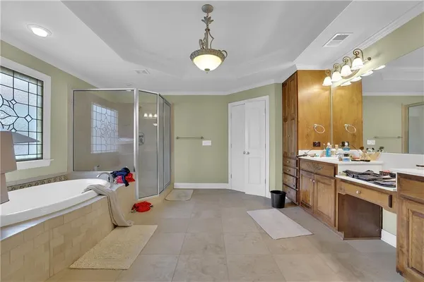 a spacious bathroom with a granite countertop tub shower and mirror