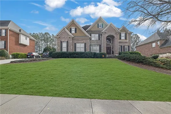 a front view of a house with a yard