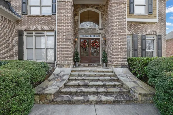 a front view of a house with a garden