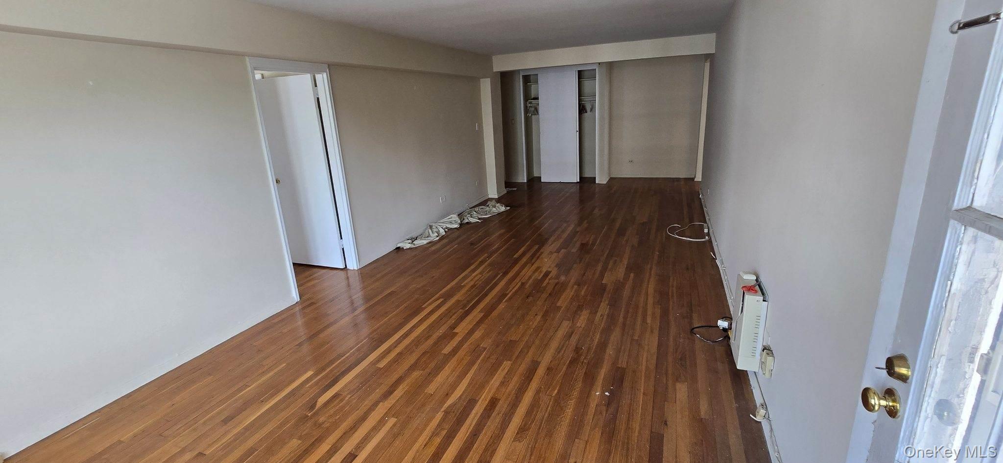 241-20 Northern Boulevard, Unit 4C Queens, NY 11362 - Photo 6 of 12 a view of a hallway with wooden floor