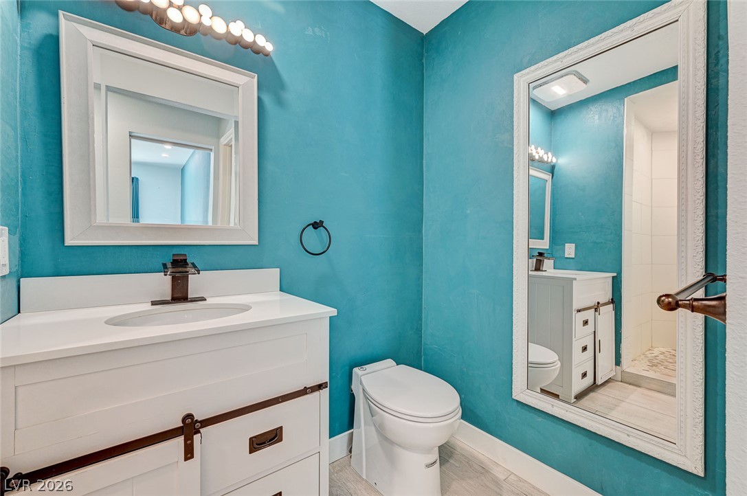 4153 Woodcrest Road Las Vegas, NV 89121 - Photo 35 of 58 A well-lit bathroom features a spacious vanity and a glass-enclosed shower, offering comfort and convenience.