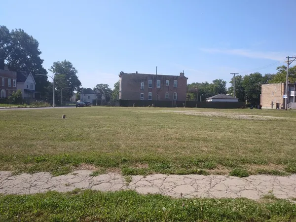 a view of a field with an ocean