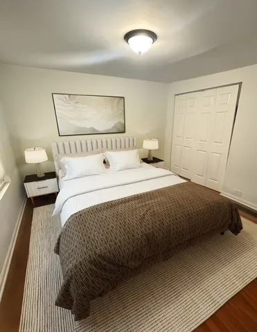 a bedroom with a bed and a mirror