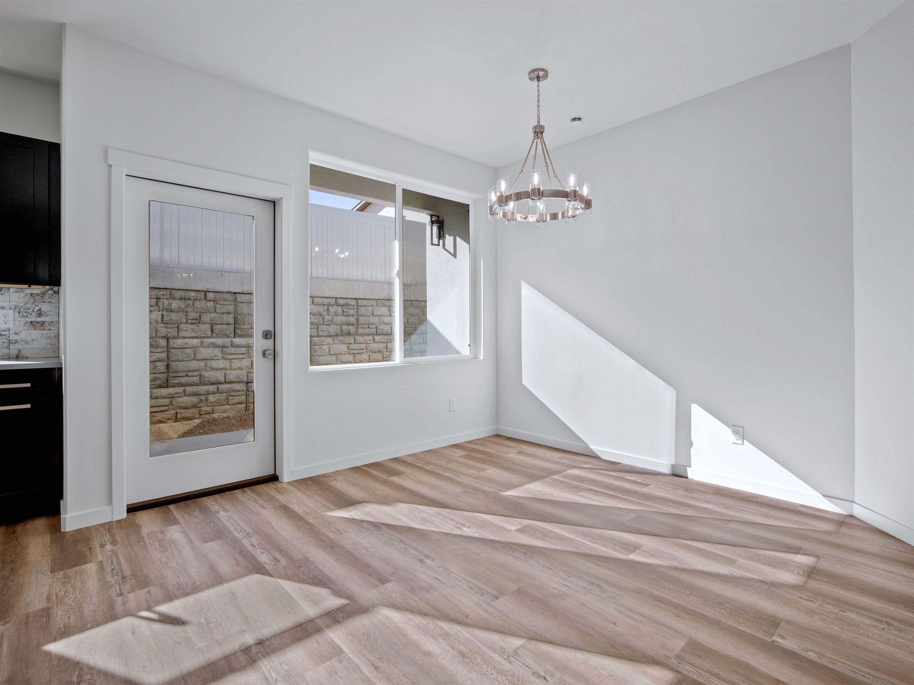215 Shadow Mesa Street, Unit AND Grand Junction, CO 81503 - Photo 25 of 42 a view of an empty room with a window and chandelier