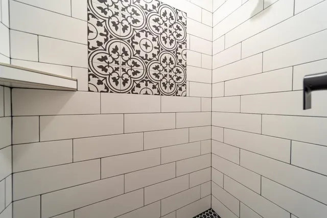 a bathroom with a granite countertop sink mirror and a bathtub