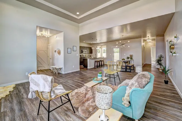 a living room with furniture and wooden floor