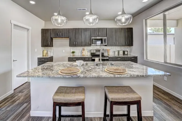 a kitchen with cabinets counter top space and stainless steel appliances