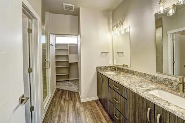 a bathroom with a double vanity sink and a mirror