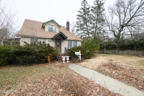 a view of a house with a yard and sitting area