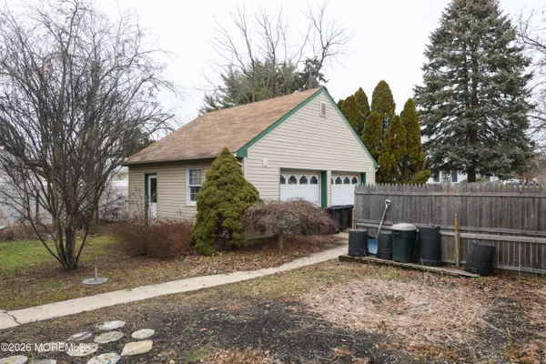 a view of a house with a yard and furniture