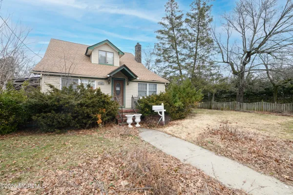 a view of a house with a yard and sitting area