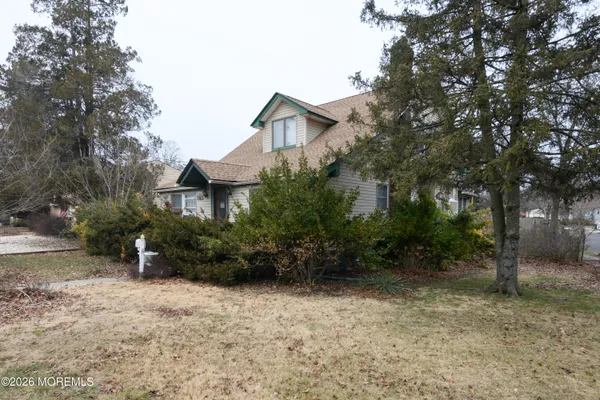 a view of a house with a yard and sitting area