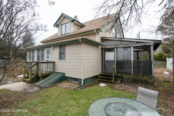 a view of a house with a yard chairs and a patio