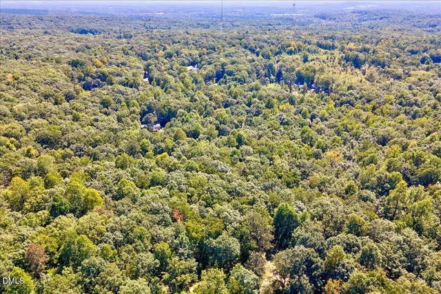 an aerial view of a houses with a yard