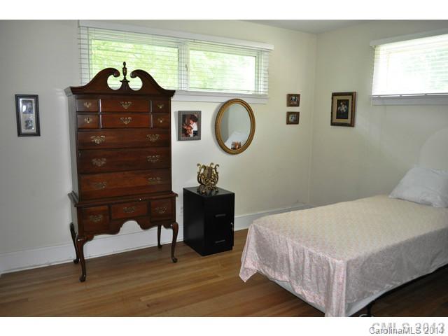 4223 Cheltenham Road, Unit 4223 Charlotte, NC 28211 - Photo 15 of 16 a bedroom with a bed a dresser and a window