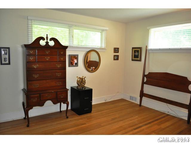 4223 Cheltenham Road, Unit 4223 Charlotte, NC 28211 - Photo 6 of 16 a living room with a dresser and a wooden floor