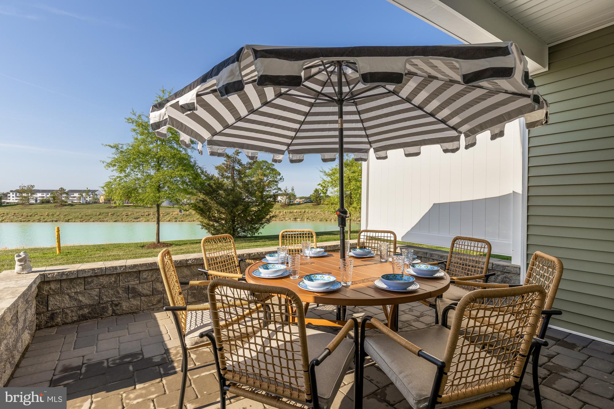 11634 Cannon Road Lewes, DE 19958 - Photo 15 of 41 a view of a patio with a table and chairs under an umbrella