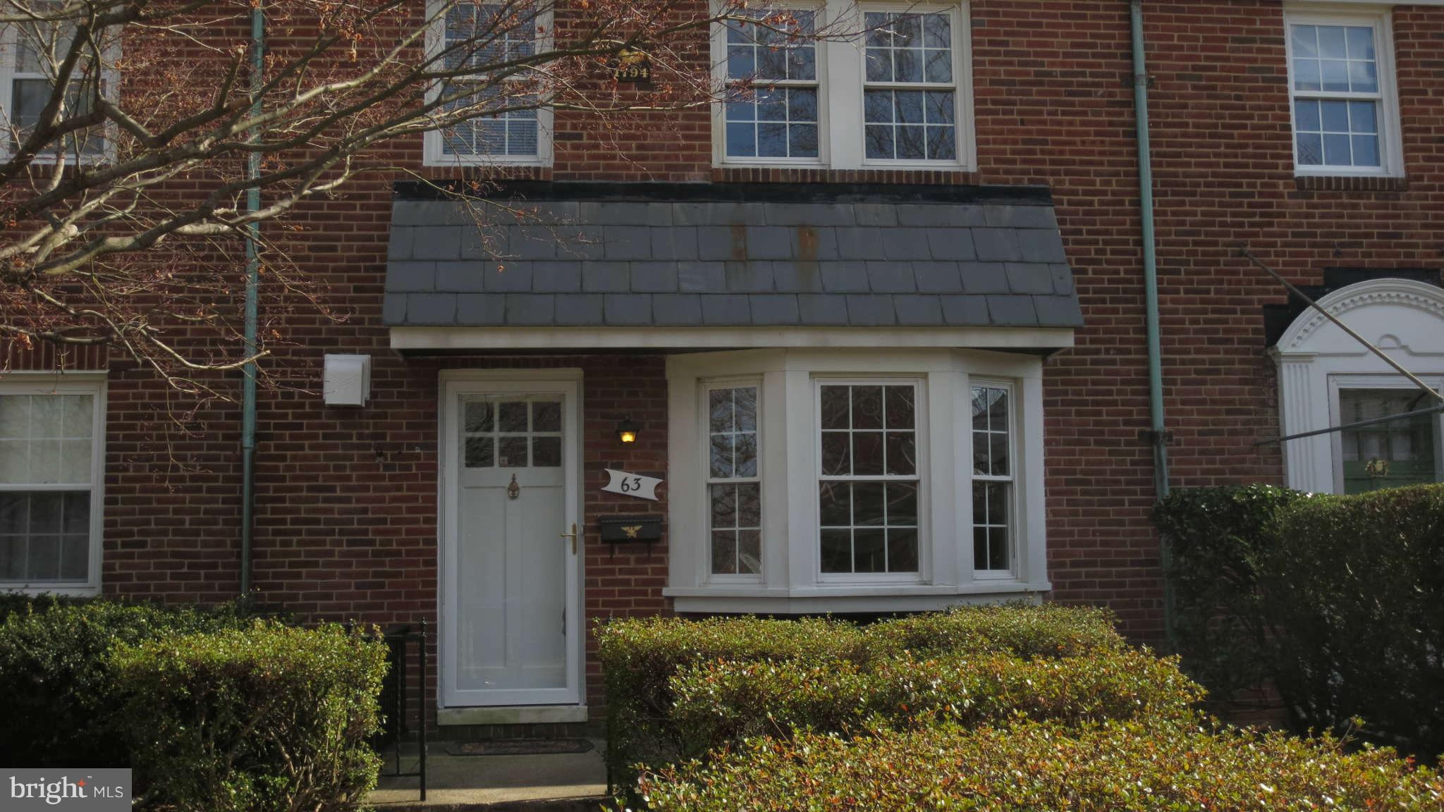 63 Murdock Road Baltimore, MD 21212 - Photo 1 of 16 front view of a brick house with a large windows