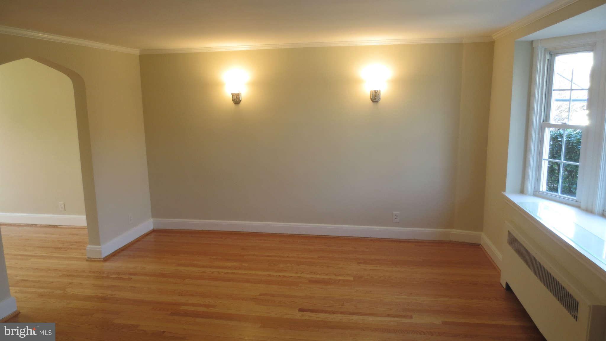 63 Murdock Road Baltimore, MD 21212 - Photo 2 of 16 an empty room with wooden floor and windows