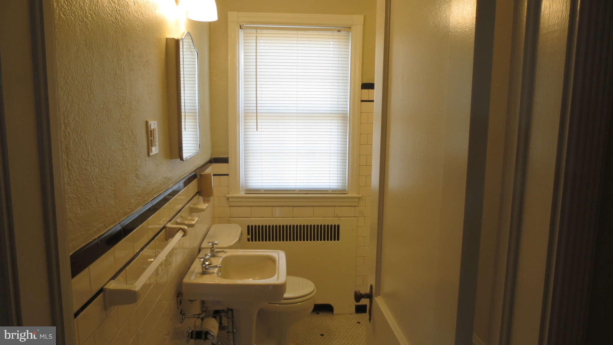 63 Murdock Road Baltimore, MD 21212 - Photo 13 of 16 a bathroom with a sink toilet and shower